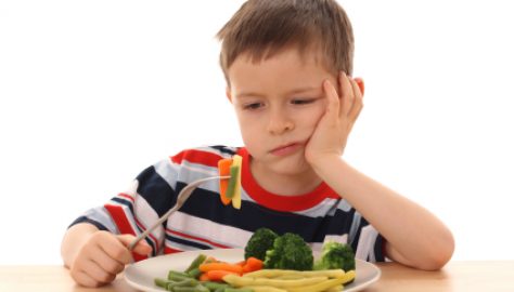 boy and cooked vegetables